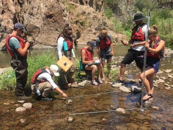 students with teacher learning about resources in the water