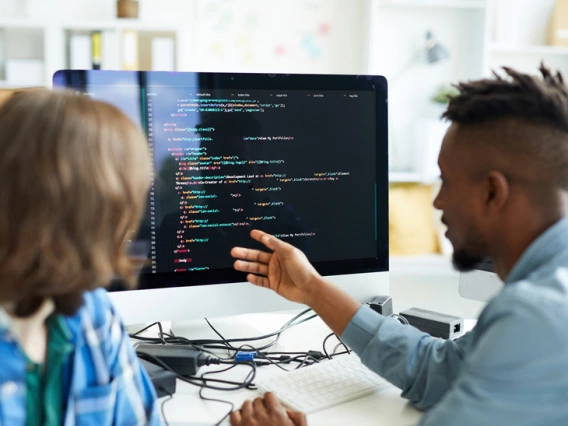 photo of man and woman at computer