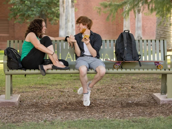 students sitting on a bench and talking