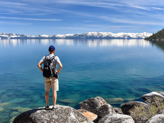 A photo of a man looking across Lake Tahoe